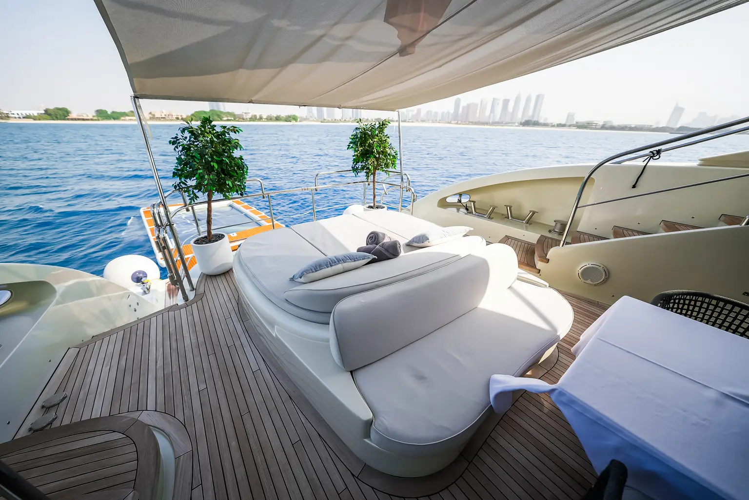 Shaded aft deck seating with sofas looking out over the water