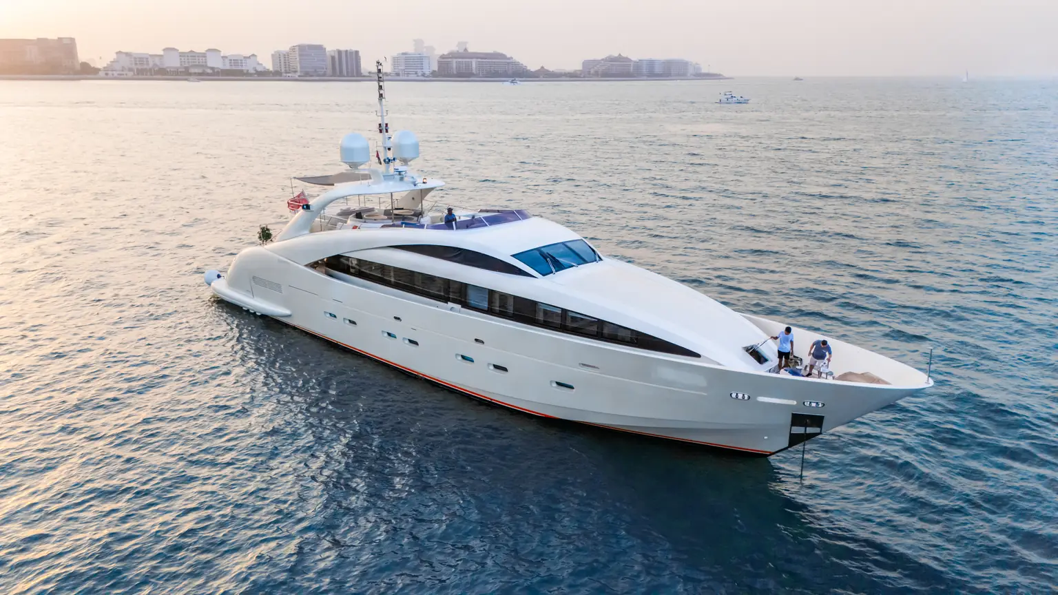 Plan B of Freedom under way with the Dubai coastline and skyline behind her